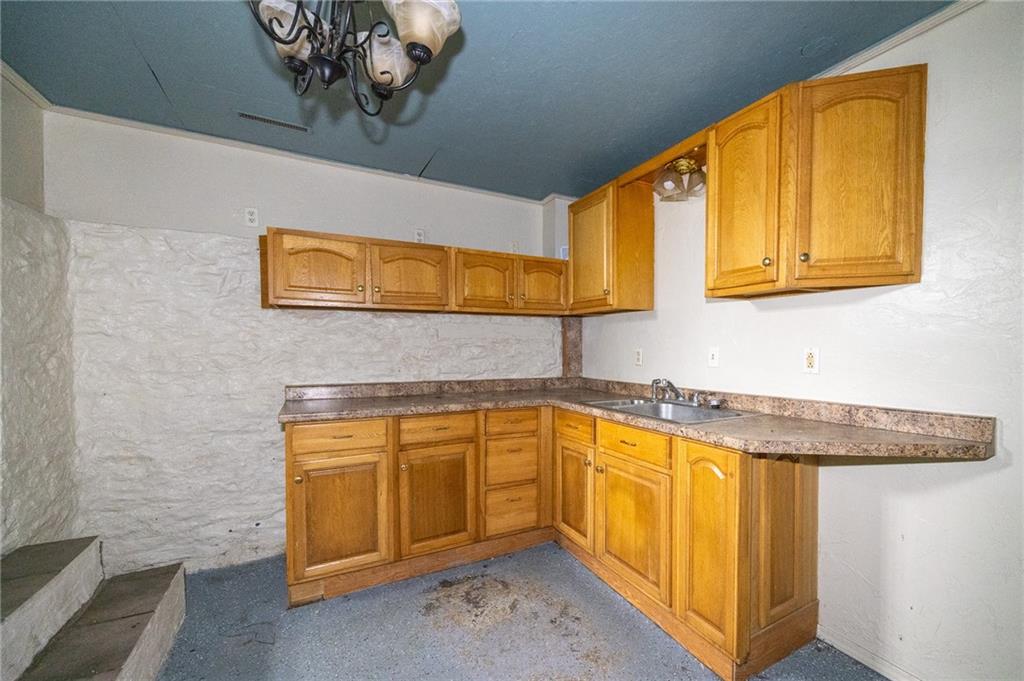 511 2nd Street Monessen, PA 15062 - Photo 19 of 21 a bathroom with a granite countertop sink and a bathtub