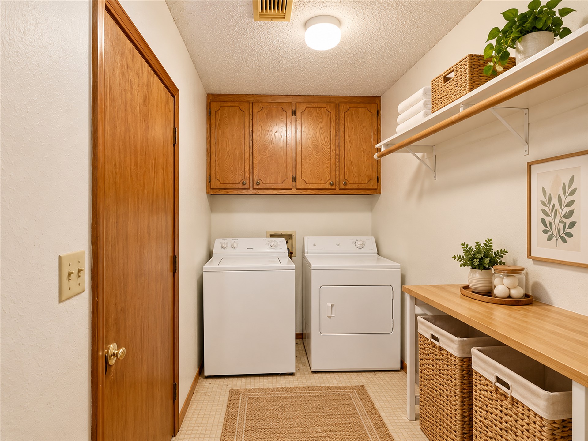 602 Northwest 4th Street Checotah, OK 74426 - Photo 12 of 28 Laundry area featuring tiled flooring, overhead cabinetry, and a built-in wood-finish countertop