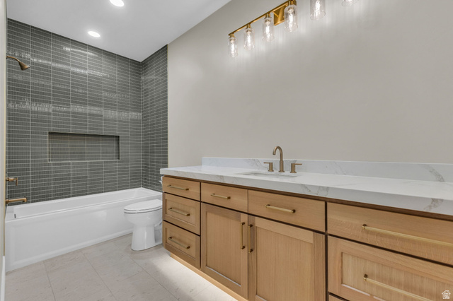 2828 Jojo Road Eagle Mountain, UT 84005 - Photo 37 of 63 Light wood-finish vanity with ample storage, a white countertop, and a built-in sink