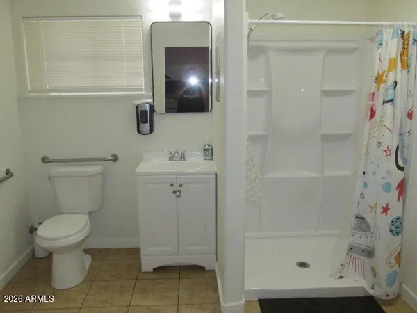 a bathroom with a toilet and a shower