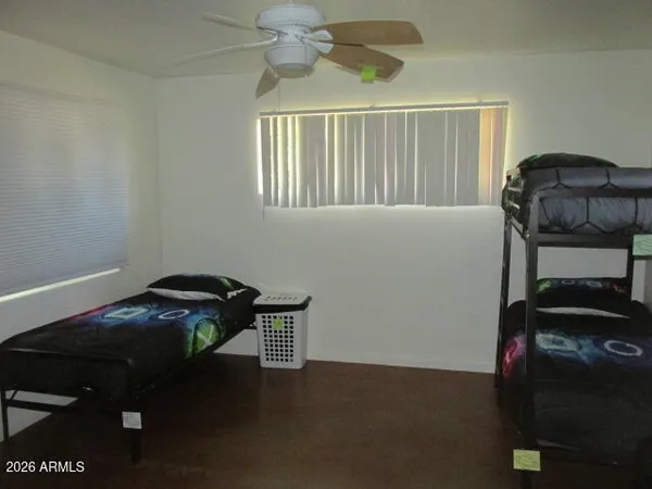 a bedroom with a bed and a window