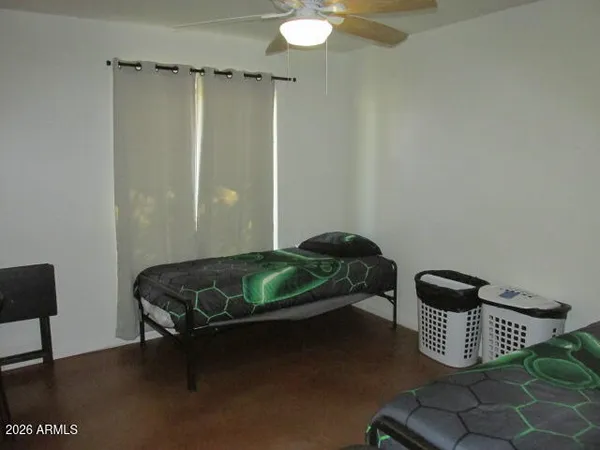 a bedroom with a bed and a chair