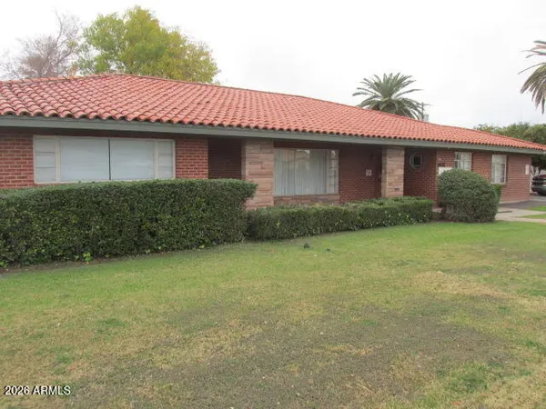 a front view of a house with garden