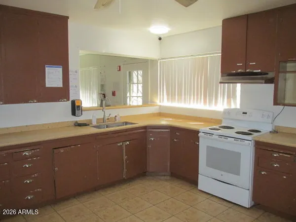 a kitchen with a sink stove and cabinets