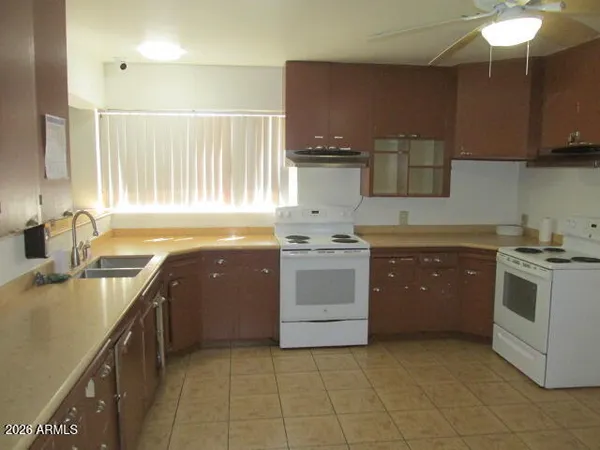 a kitchen with a stove sink and cabinets