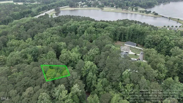 an aerial view of a house with a yard and lake view