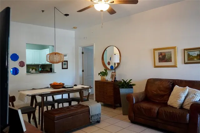 a living room with furniture a rug and a chandelier