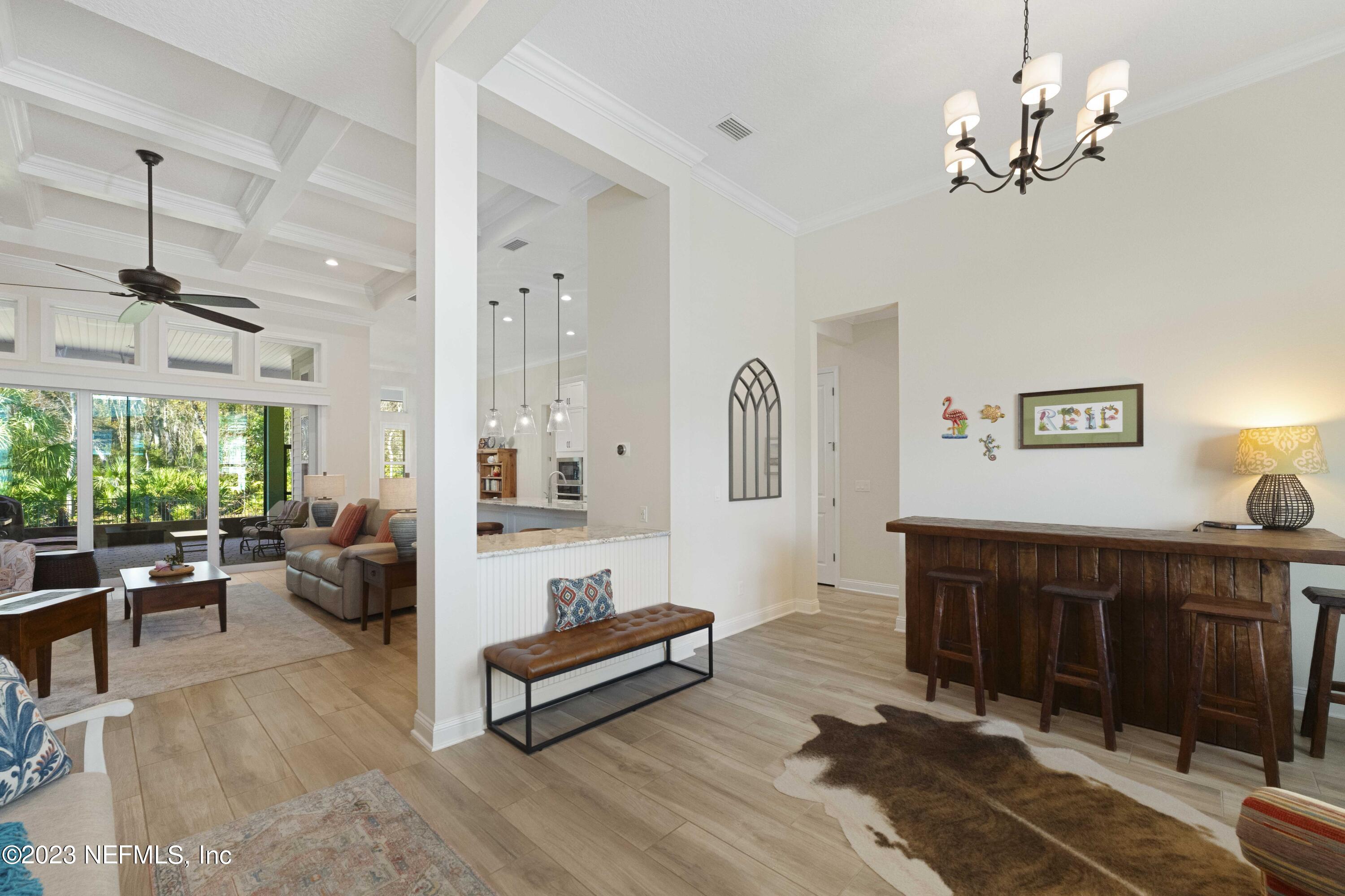 515 Park Forest Drive Ponte Vedra, FL 32081 - Photo 5 of 106 a living room with furniture a window and a chandelier
