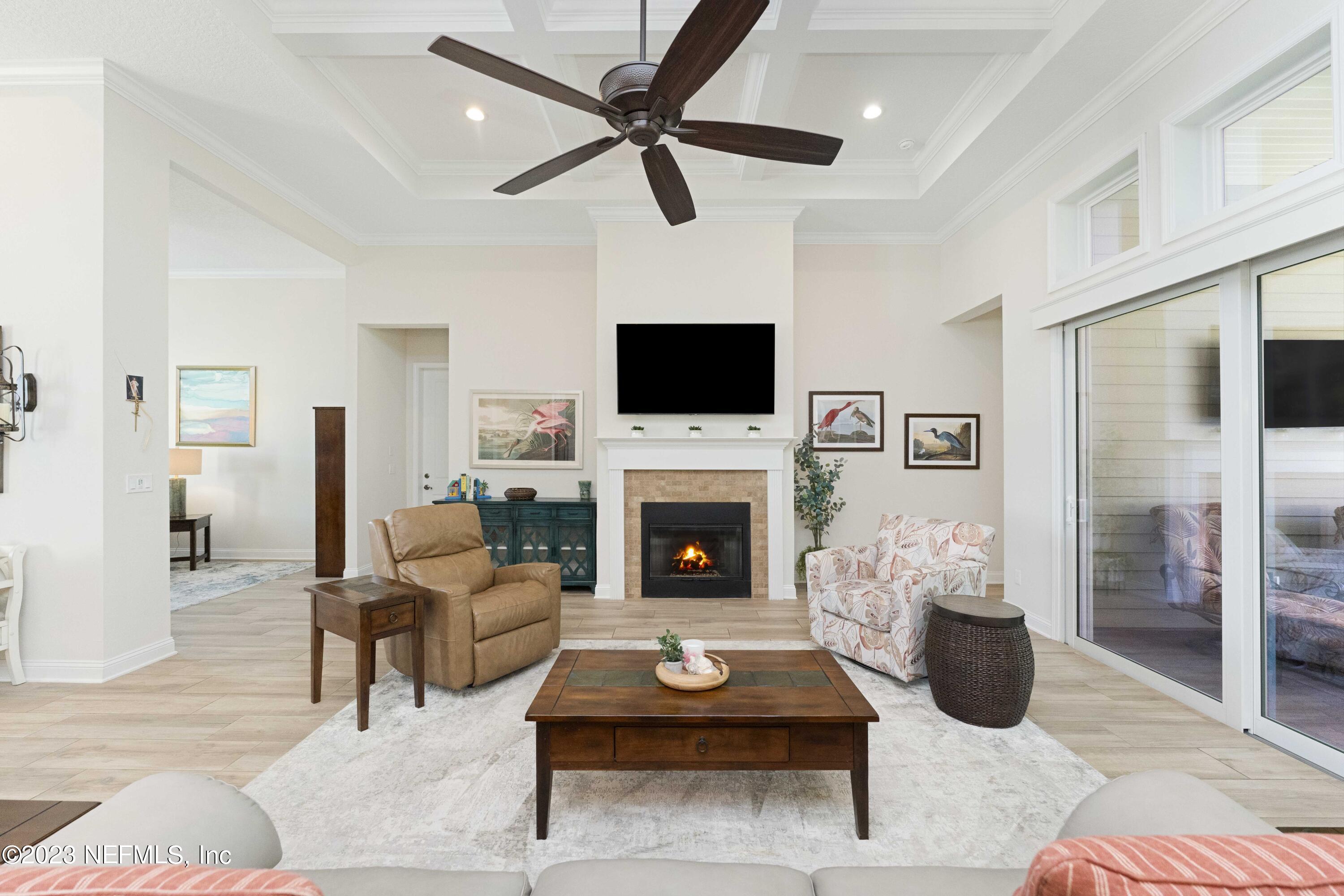 515 Park Forest Drive Ponte Vedra, FL 32081 - Photo 8 of 106 a living room with furniture a fireplace and a flat screen tv