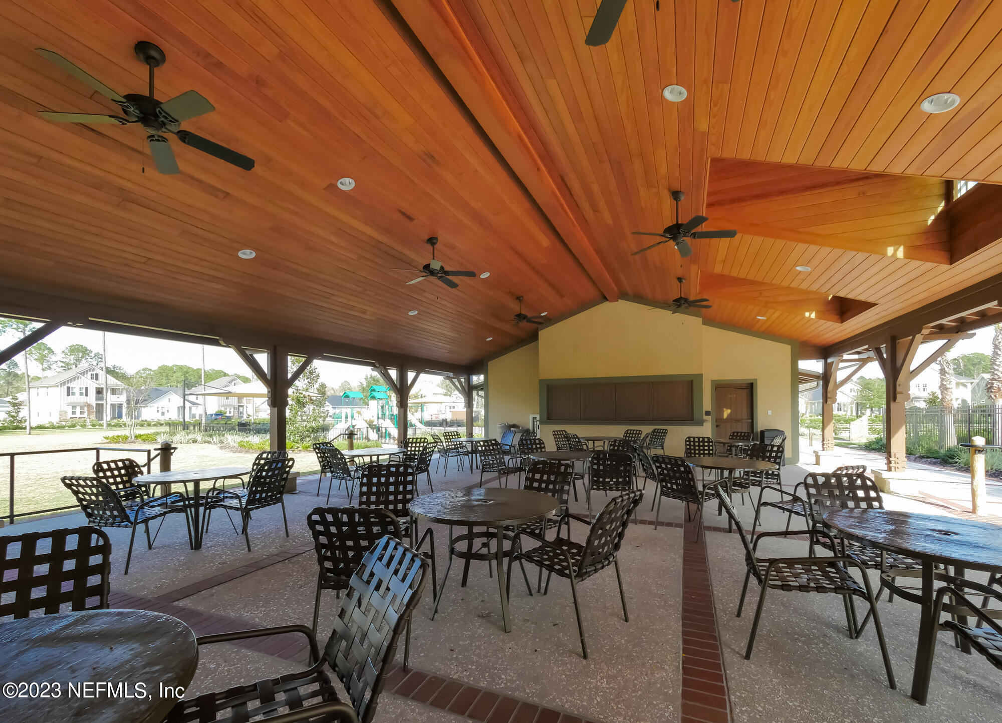 515 Park Forest Drive Ponte Vedra, FL 32081 - Photo 97 of 106 a outdoor space with lots of tables a large window and chairs