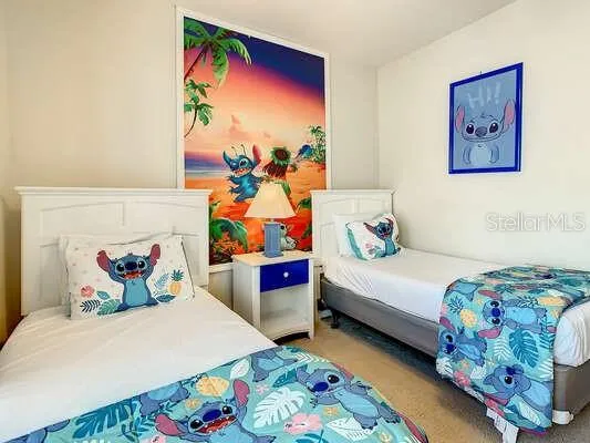 a bedroom with two beds and a window