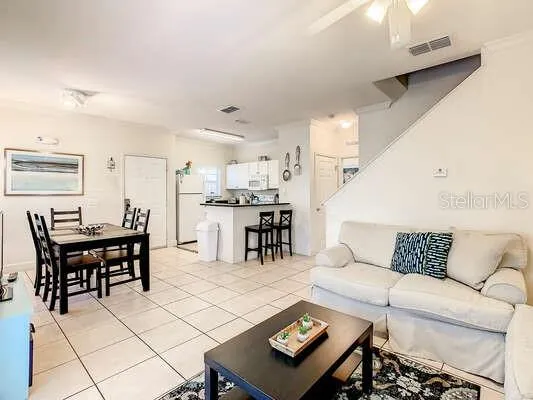 a living room with furniture and kitchen view