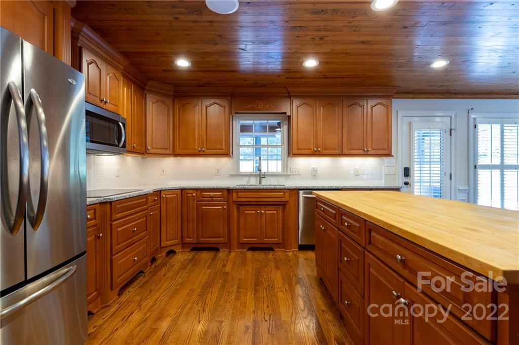 200 Range Road Kings Mountain, NC 28086 - Photo 20 of 45 a kitchen with stainless steel appliances granite countertop wooden cabinets a stove top oven a sink and dishwasher with wooden floor