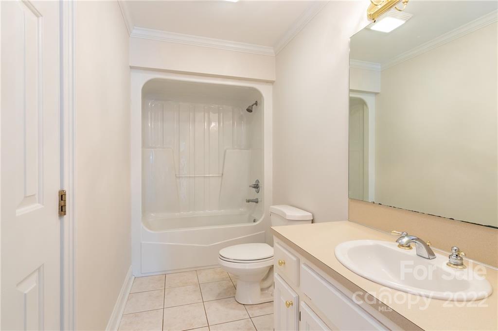 200 Range Road Kings Mountain, NC 28086 - Photo 29 of 45 a bathroom with a granite countertop toilet a sink and a bathtub