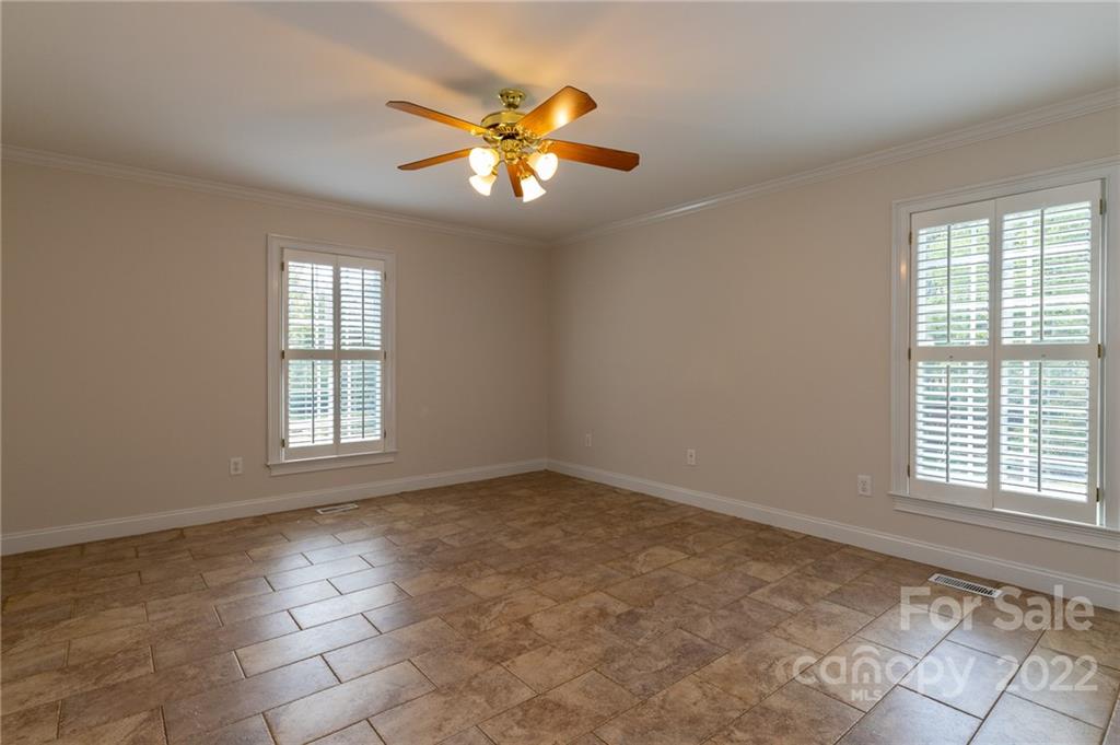 200 Range Road Kings Mountain, NC 28086 - Photo 30 of 45 an empty room with windows and chandelier fan