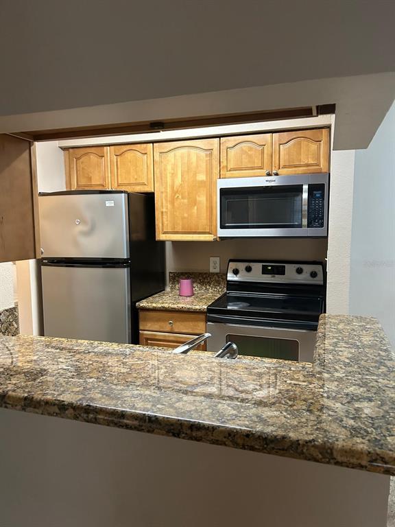 238 Afton Square, Unit 305 Altamonte Springs, FL 32714 - Photo 5 of 13 a view of kitchen with microwave and stove