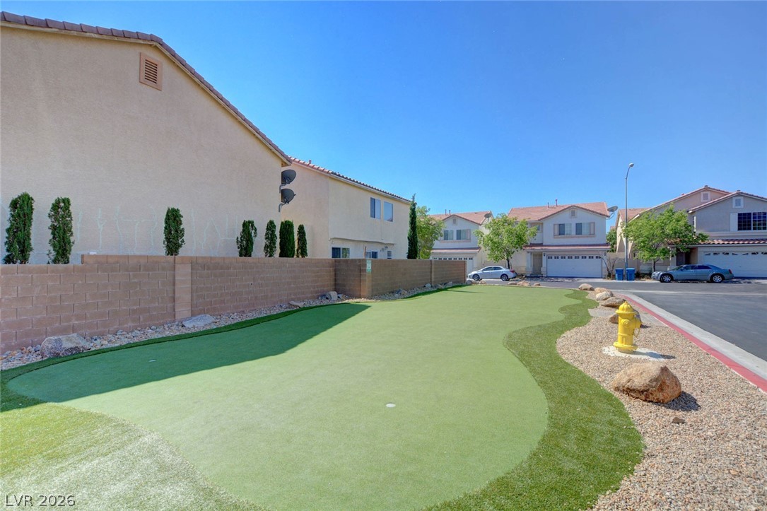 7259 Cestrum Road Las Vegas, NV 89113 - Photo 30 of 35 A private backyard oasis features an artificial turf putting green for endless recreation.