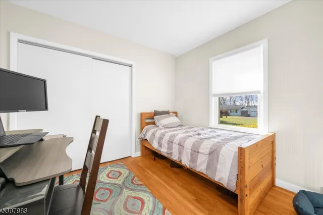 a bedroom with a bed and a desk in it