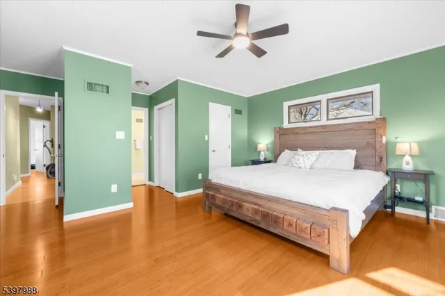 a spacious bedroom with a bed and a chandelier
