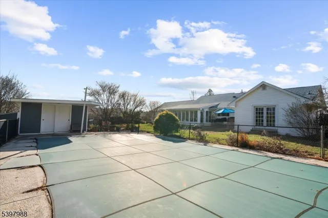 a backyard of a house with table and chairs