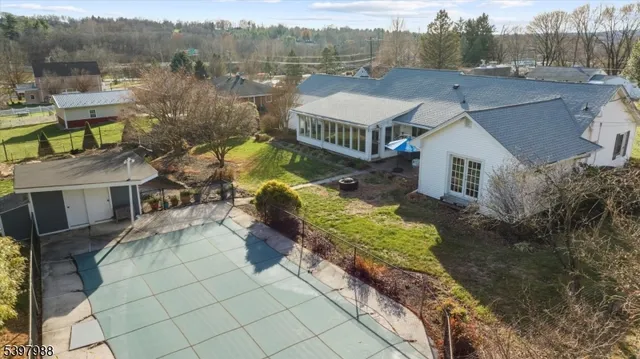 a front view of a house with a yard and mountain view in back