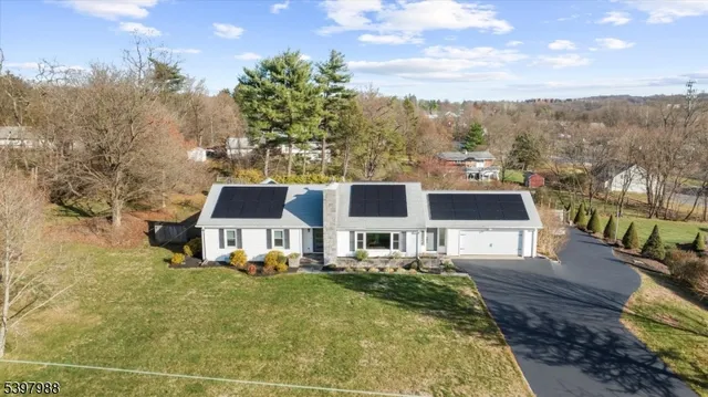a view of a house with pool and chairs