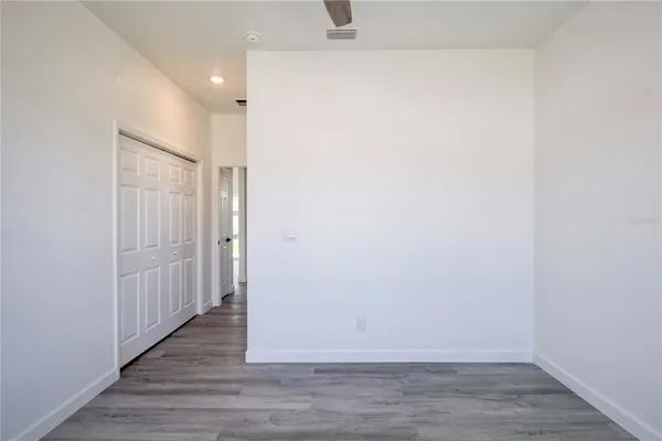 a view of a hallway with wooden floor