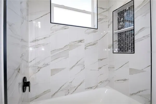 a bathroom with a bathtub and shower