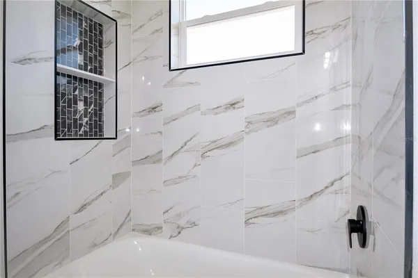 a bathroom with bathtub and shower