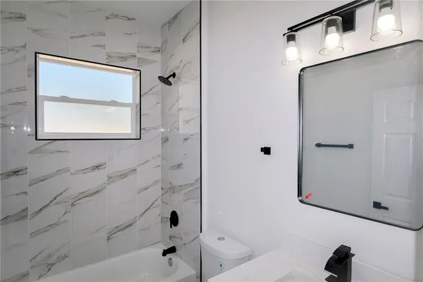 a bathroom with a bathtub and shower