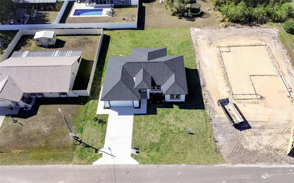 an aerial view of a house with a swimming pool