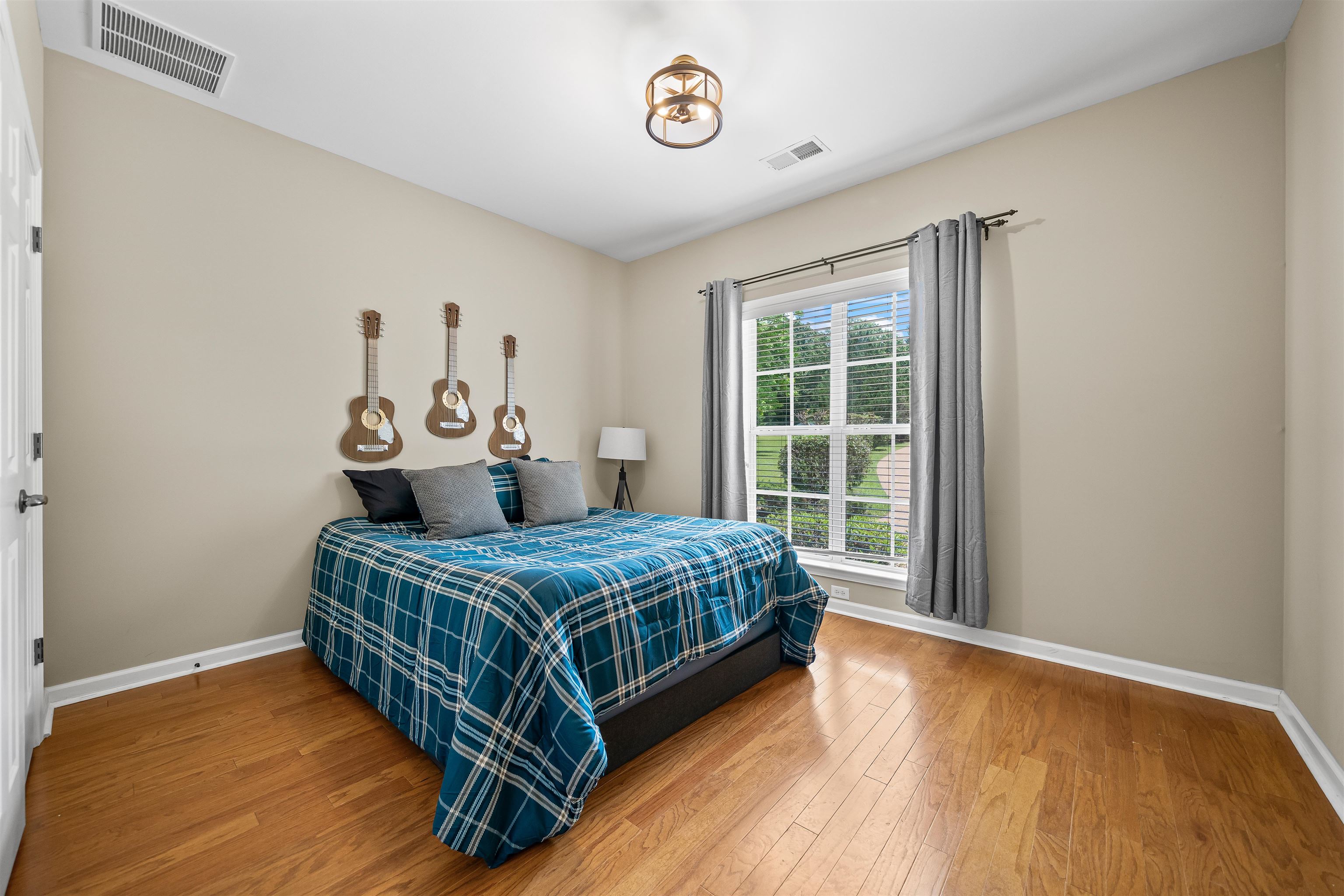 5035 Brian Ridge Road Arlington, TN 38002 - Photo 22 of 40 Bright room featuring wood-finish flooring, a large window with white muntins, and neutral wall tones