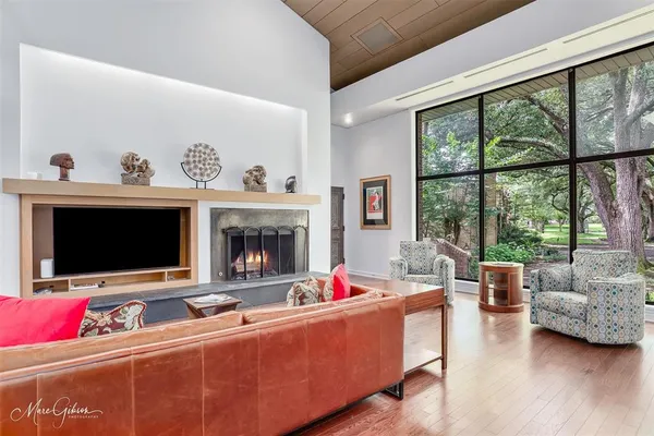 a living room with furniture fireplace and flat screen tv