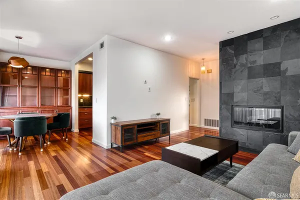 a living room with furniture a wooden floor and a window