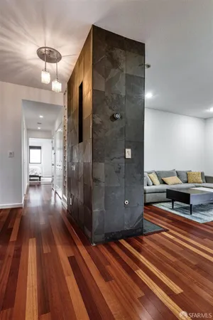 a view of a hallway with wooden floor