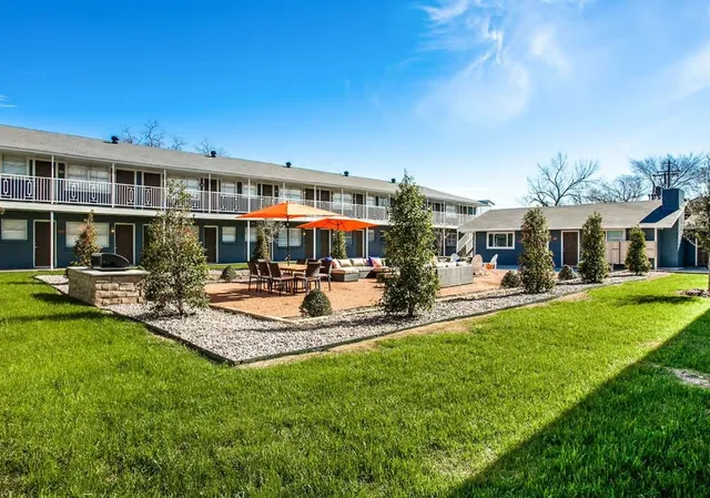 a front view of a house with garden and sitting area