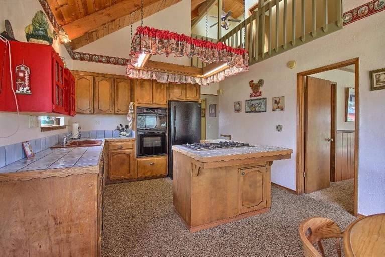 36141 Wells Road Coarsegold, CA 93614 - Photo 6 of 10 Kitchen with high cathedral ceilings, and loft/hallway seen in upper right of picture.