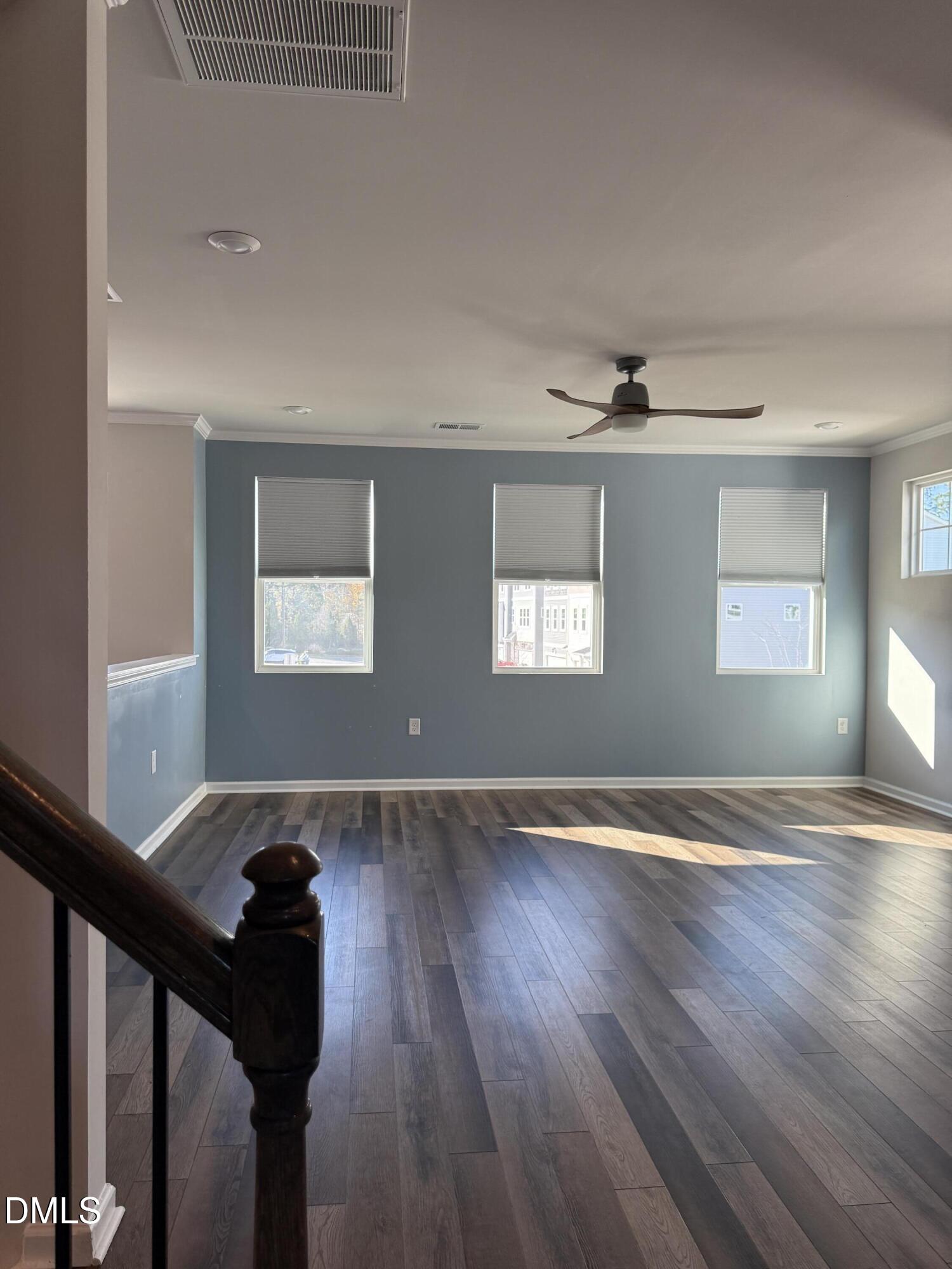 1092 Shoreside Drive Durham, NC 27713 - Photo 4 of 6 a view of an empty room with wooden floor and windows
