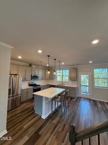 a large kitchen with a table and chairs