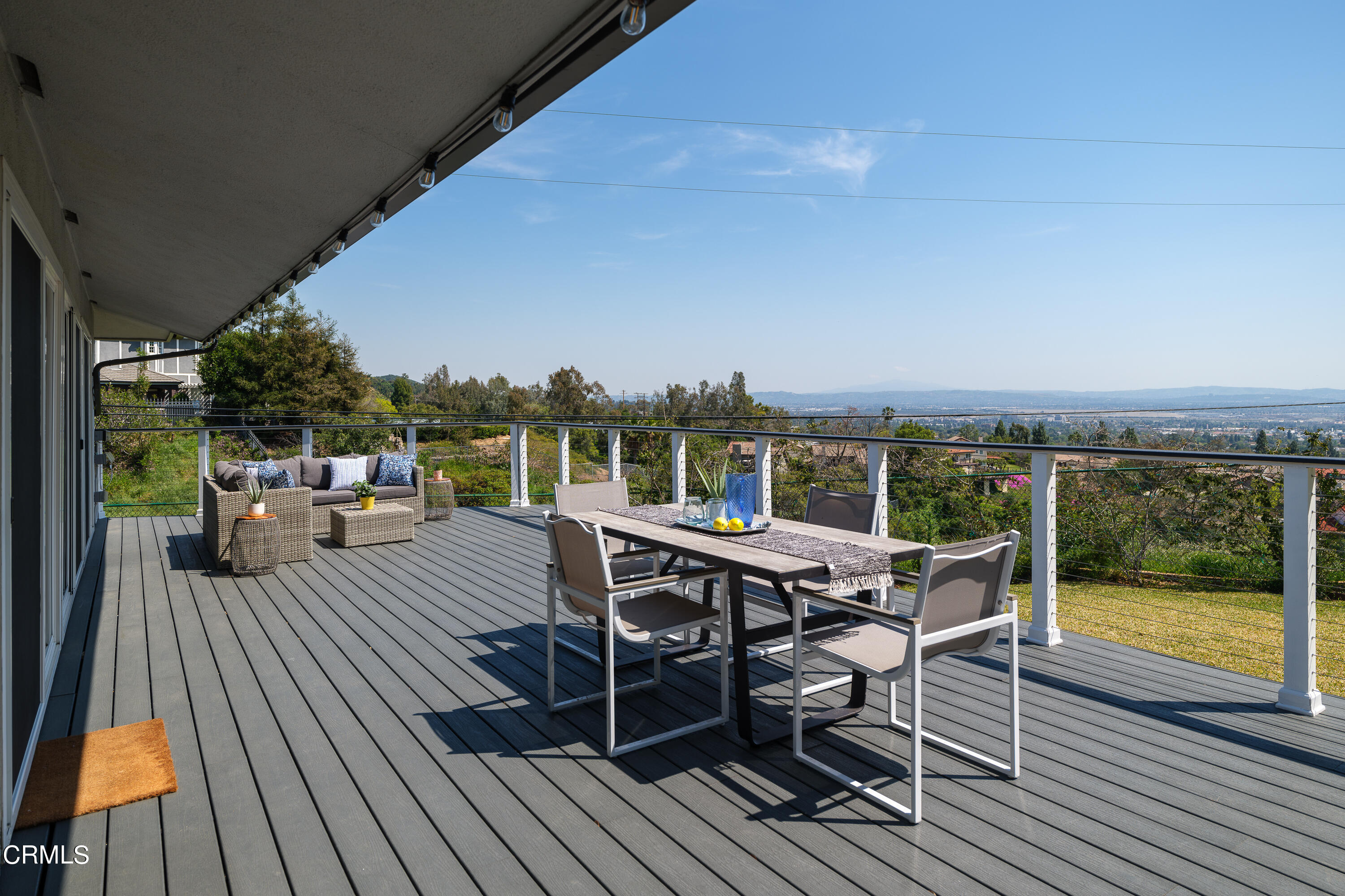 1020 Briarcliff Road Monrovia, CA 91016 - Photo 42 of 72 a view of a roof deck with table and chairs a barbeque with wooden floor and fence