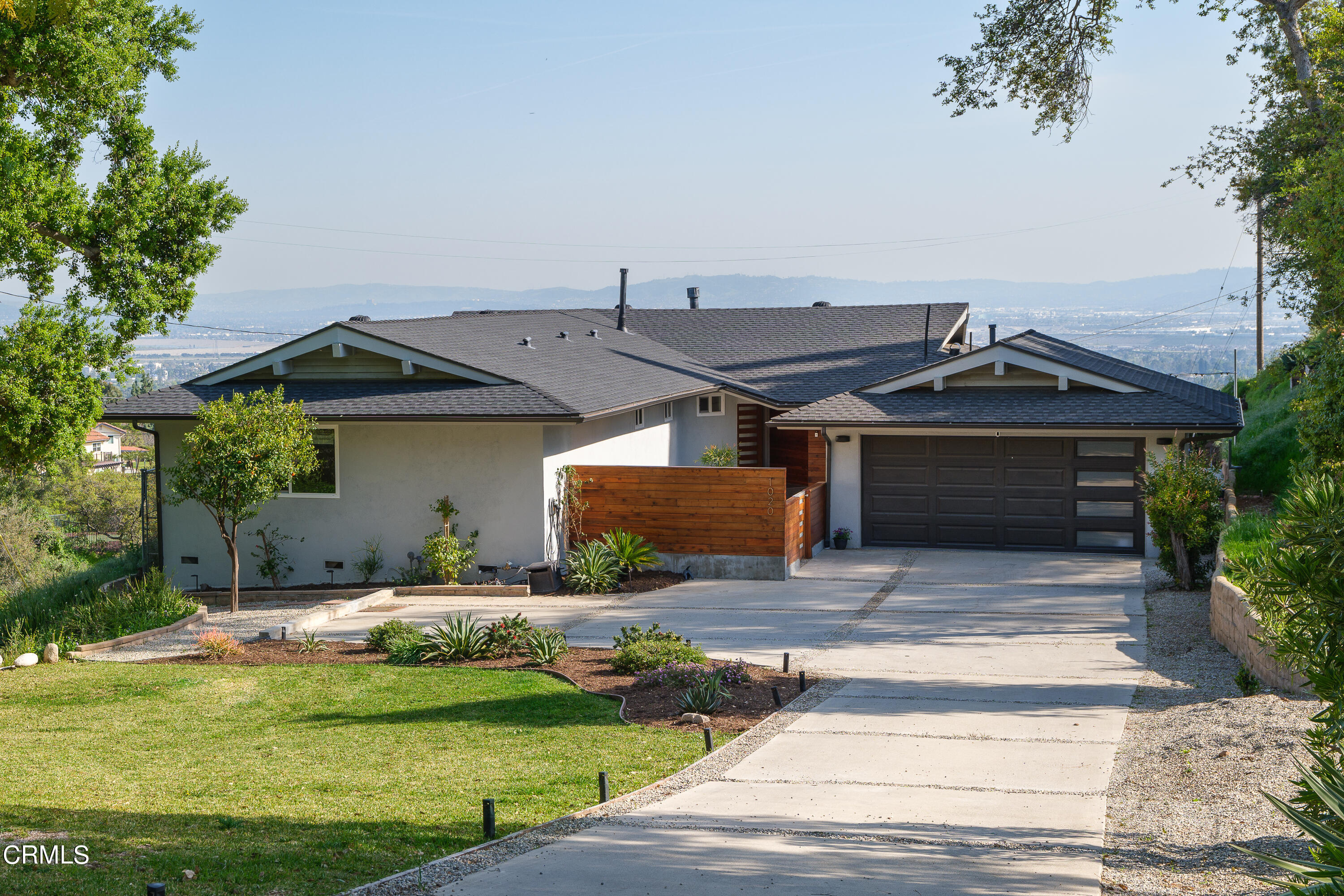 1020 Briarcliff Road Monrovia, CA 91016 - Photo 5 of 72 a front view of a house with a garden and yard