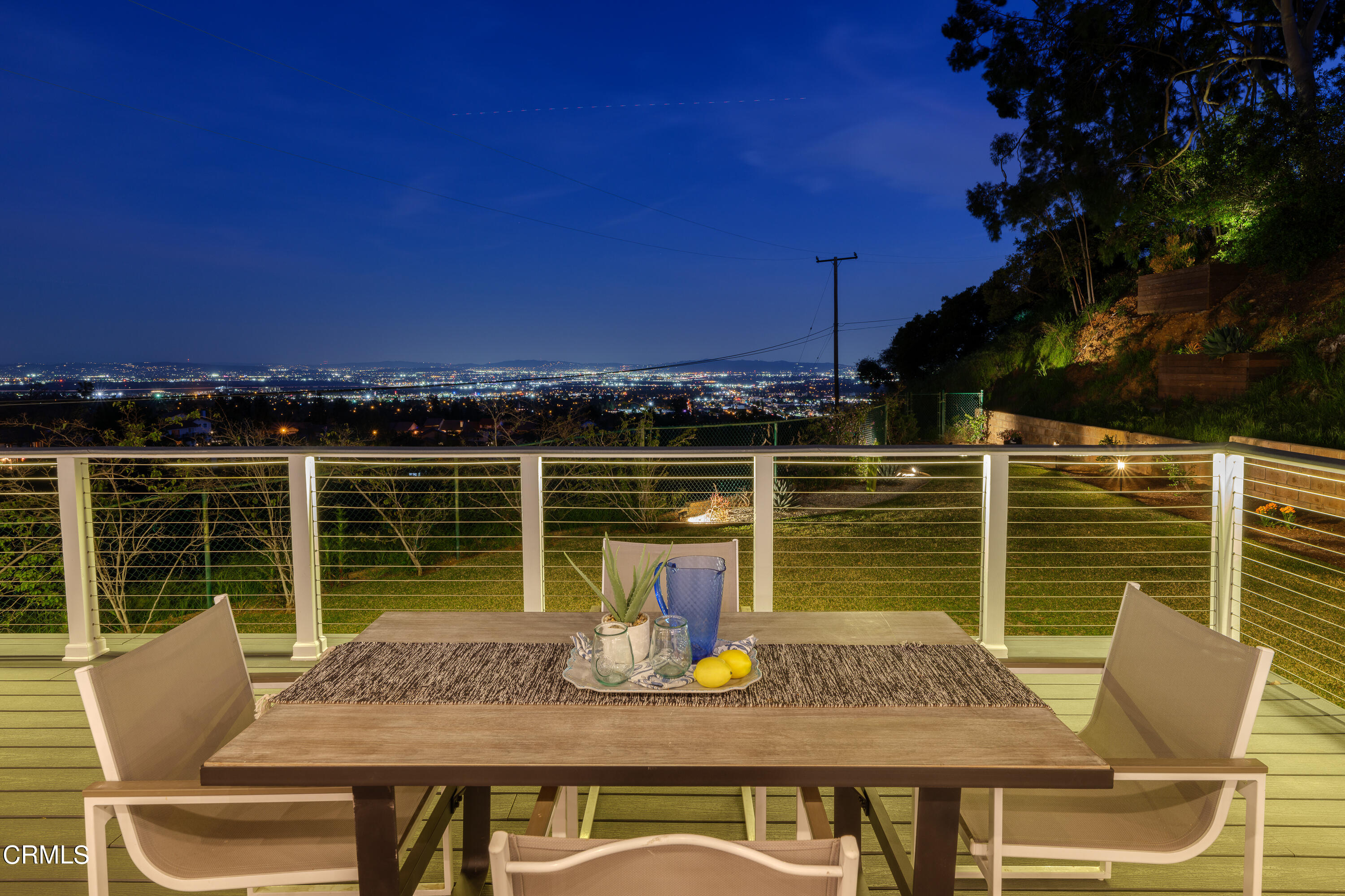 1020 Briarcliff Road Monrovia, CA 91016 - Photo 71 of 72 a view of a balcony with dining table and chairs with wooden floor and fence