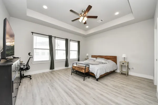 a bedroom with a bed and a large window