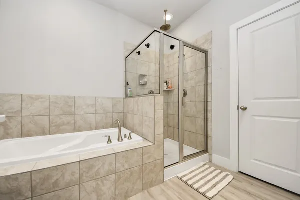 a bathroom with a bathtub and a shower