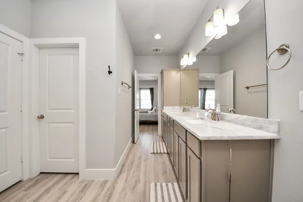 a bathroom with a sink vanity and a mirror