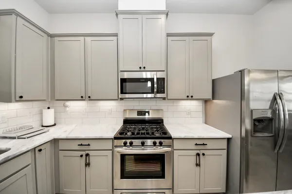 a kitchen with cabinets stainless steel appliances and a sink