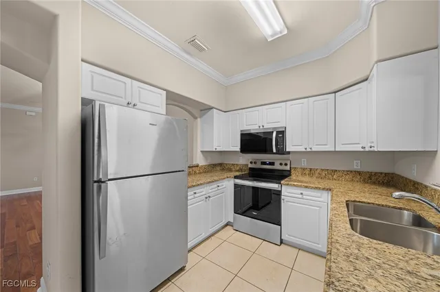 a white refrigerator freezer and a stove in a kitchen