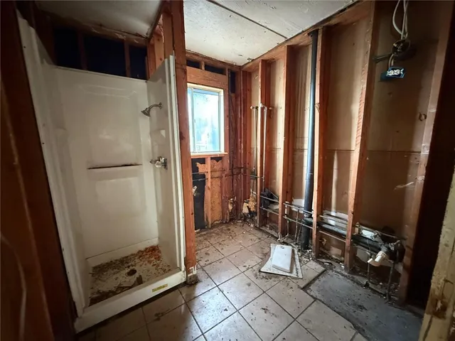 a bathroom with a shower and a mirror
