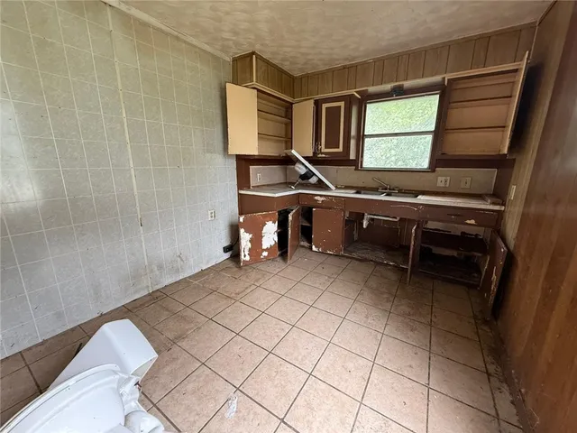 a room with a sink a mirror and a window