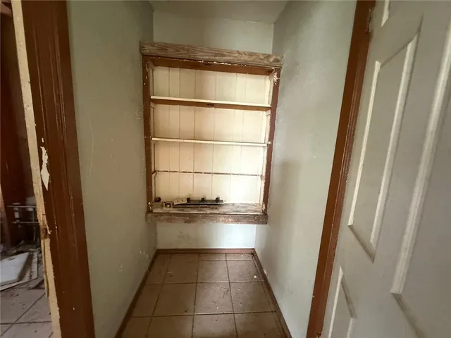a kitchen with a refrigerator and cabinets